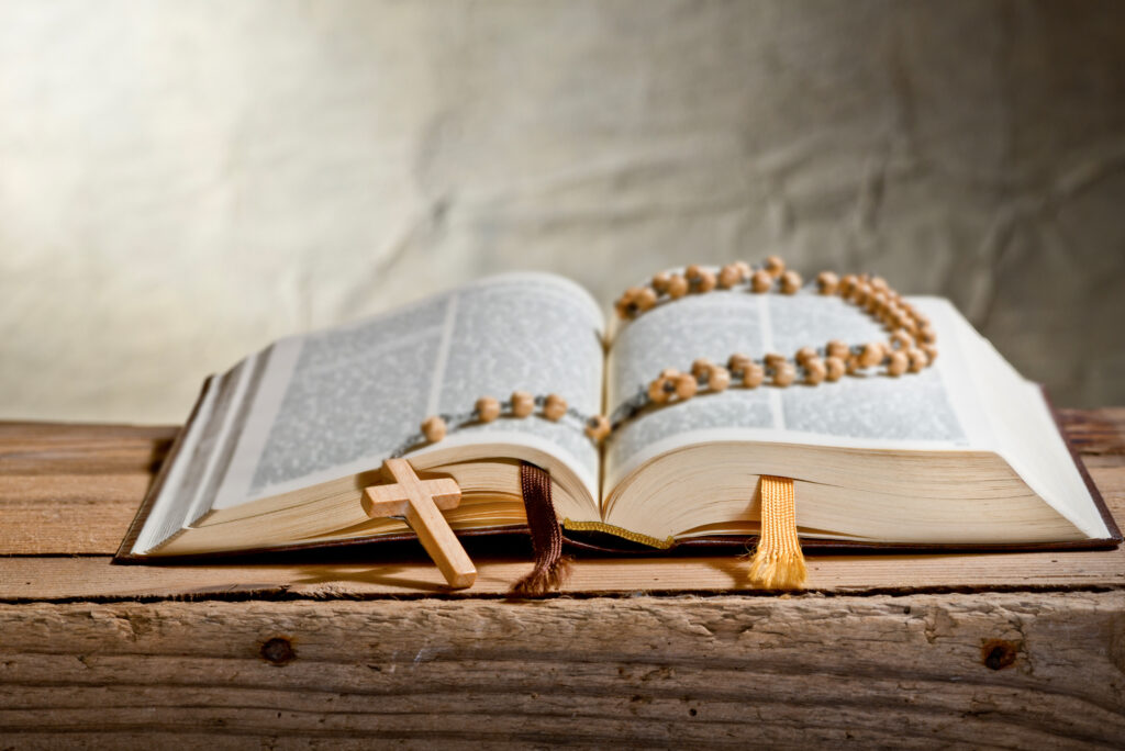Rosary With Old Bible on the Desk